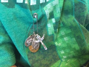 Jude Cobler wears a pin with silver and gold medals -- St. Peregrine, the Holy Spirit and the Miraculous Medal of Mary. It's pinned right above Jude's heart. Photo/Lauren Silverman