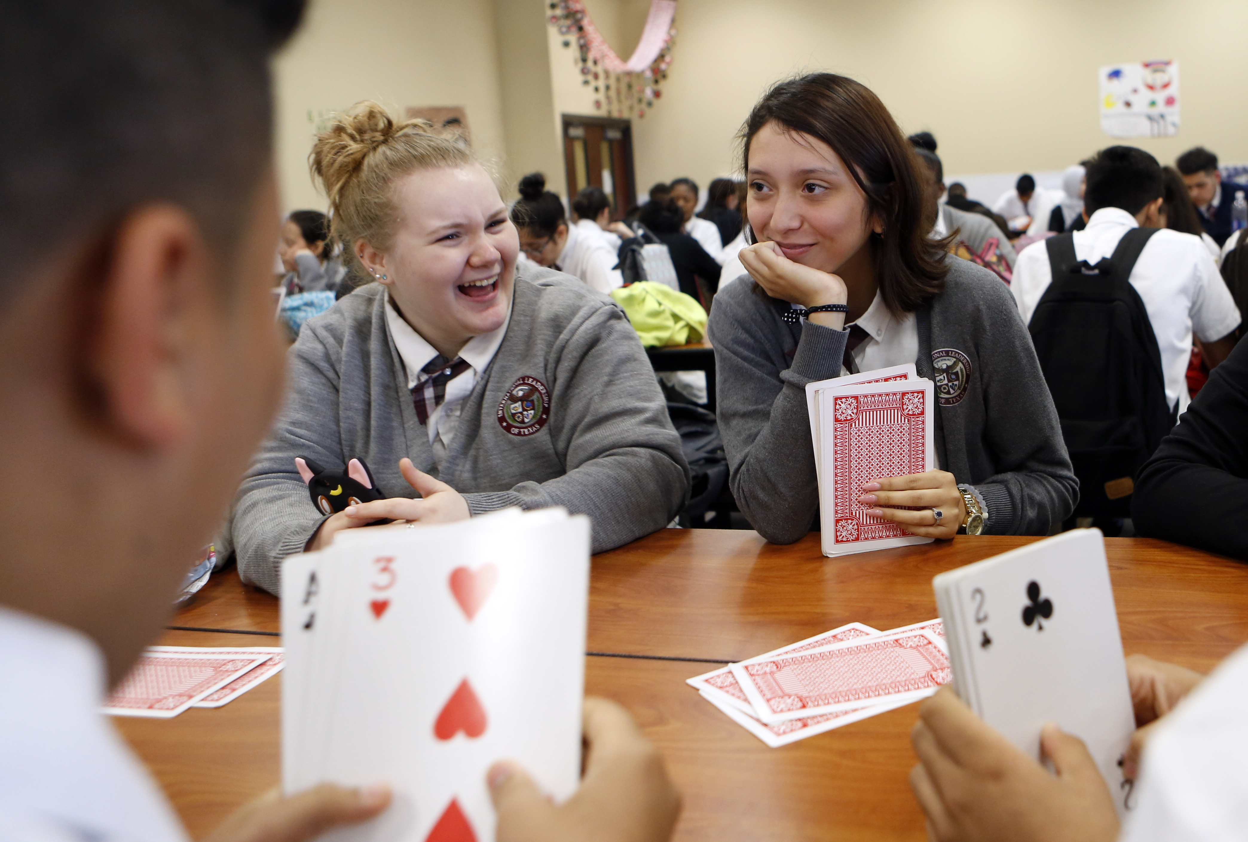 Alex Gutierrez, right, and Juliet Wickersham play a card game during lunch at International Leadership of Texas Garland High School. Photo/Lara Solt
