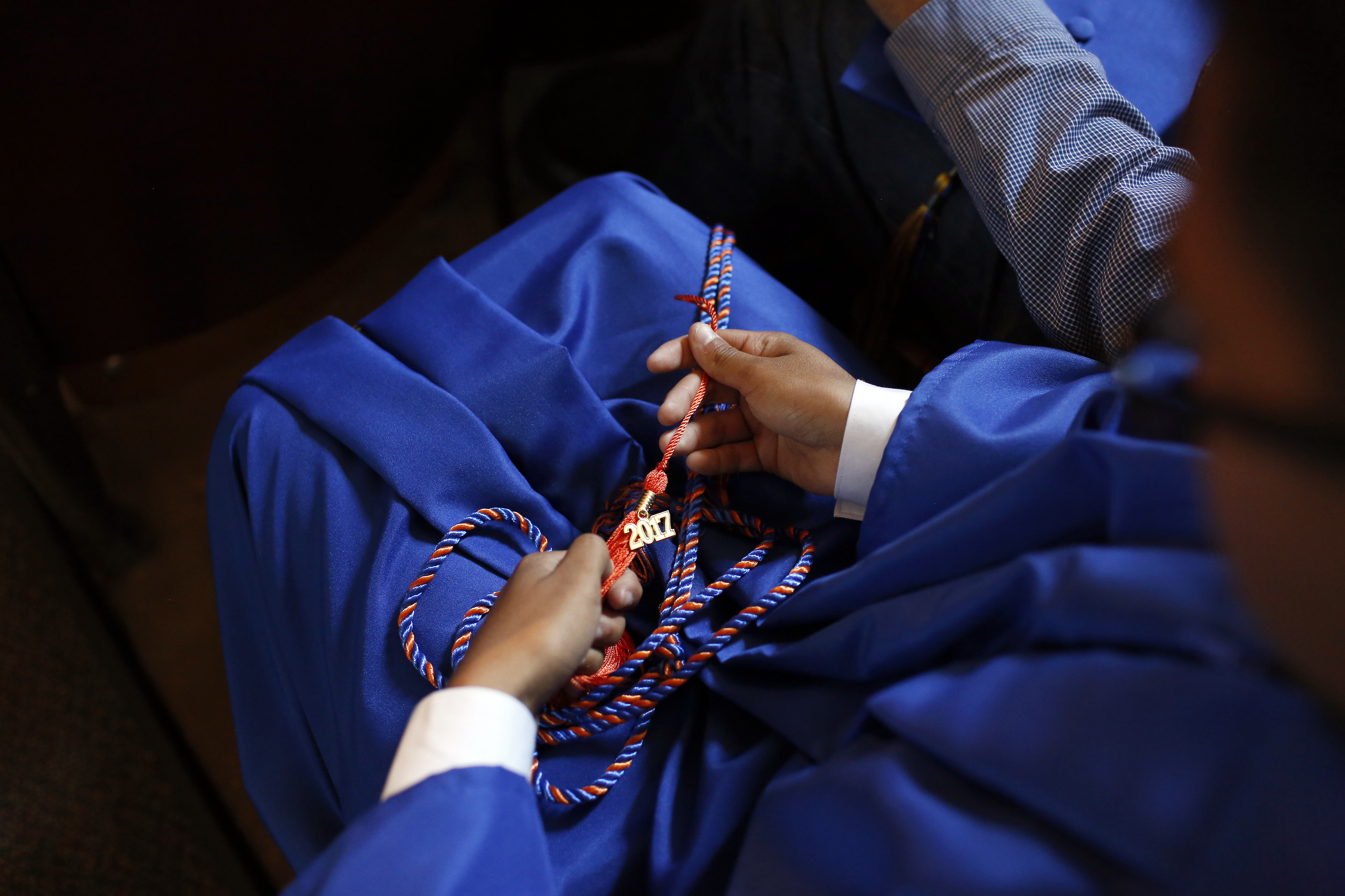 Joel Luera receives an honor cord and a 2017 graduation tassel while attending a Gratitude Ceremony for W. W. Samuell Early College High School in Dallas, Texas on Saturday, May 6, 2017. (photo © Lara Solt)