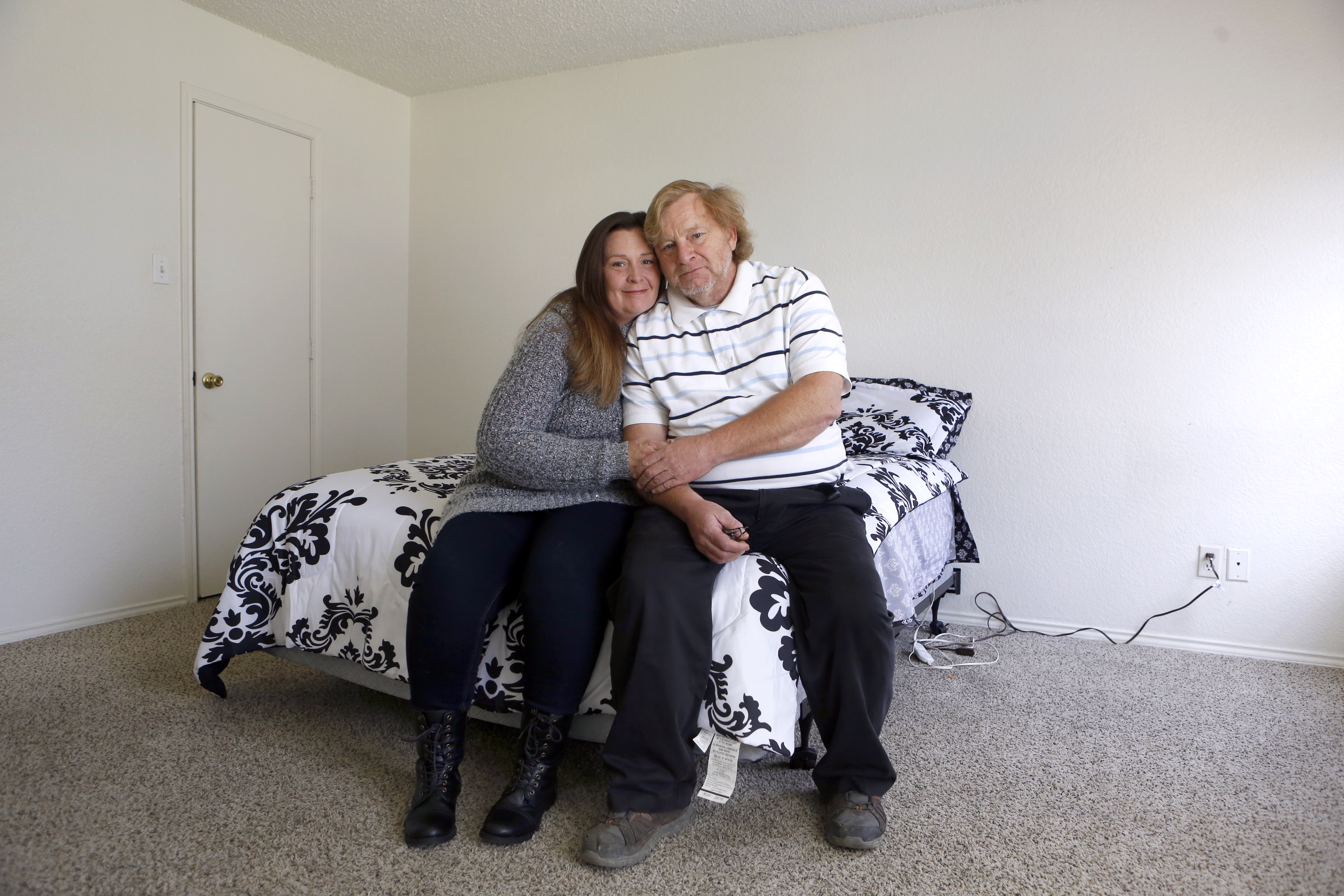 After three years staying in motels, the Rosenheim family just moved into a three-bedroom home where each child has their own bed. Parents Belinda and Dave in the bedroom they share. (photo copyright Lara Solt)