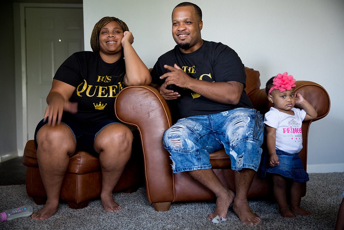 Stanley Walington and his girlfriend Lynette Sherman, with their youngest daughter in their apartment in Fort Worth