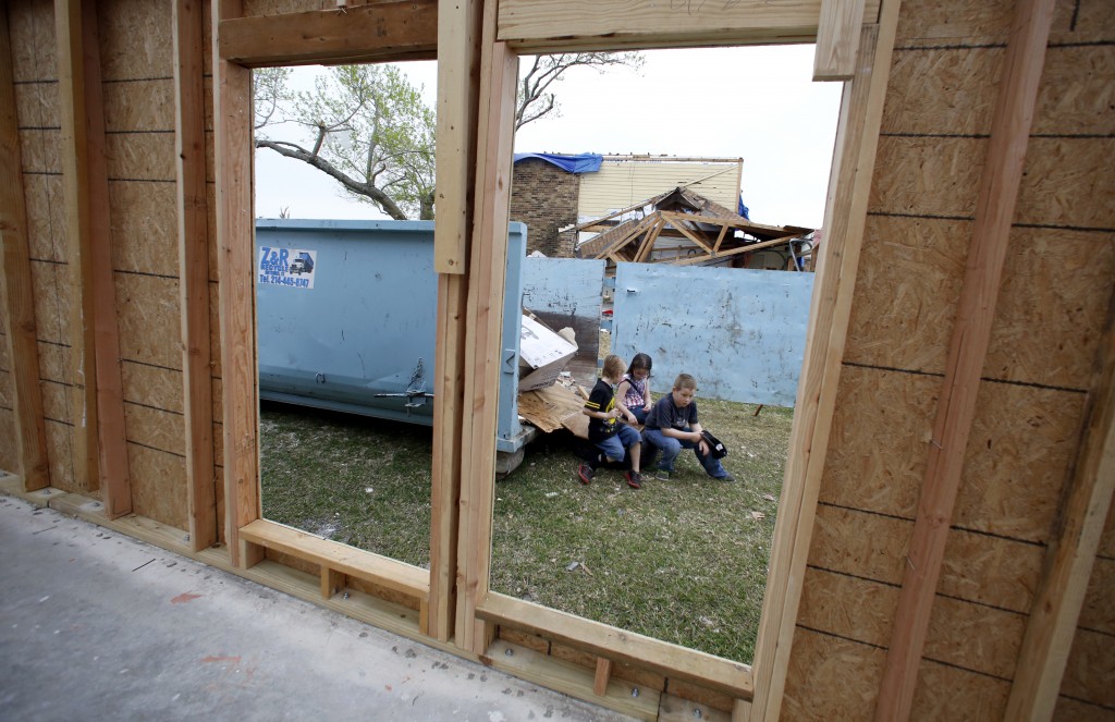 Kaden Beck, 6 (from left), Kairi Beck, 8, and Joshua Tucker, 9 play in the yard at their Garland home where their parents have already started the process of rebuilding after their house was seriously damaged in the December tornadoes. They did not have rental insurance and are now renting a new place which is a little smaller and $200 more per month, which hurts. Photographed Sunday, February 21, 2016. (photo copyright Lara Solt)