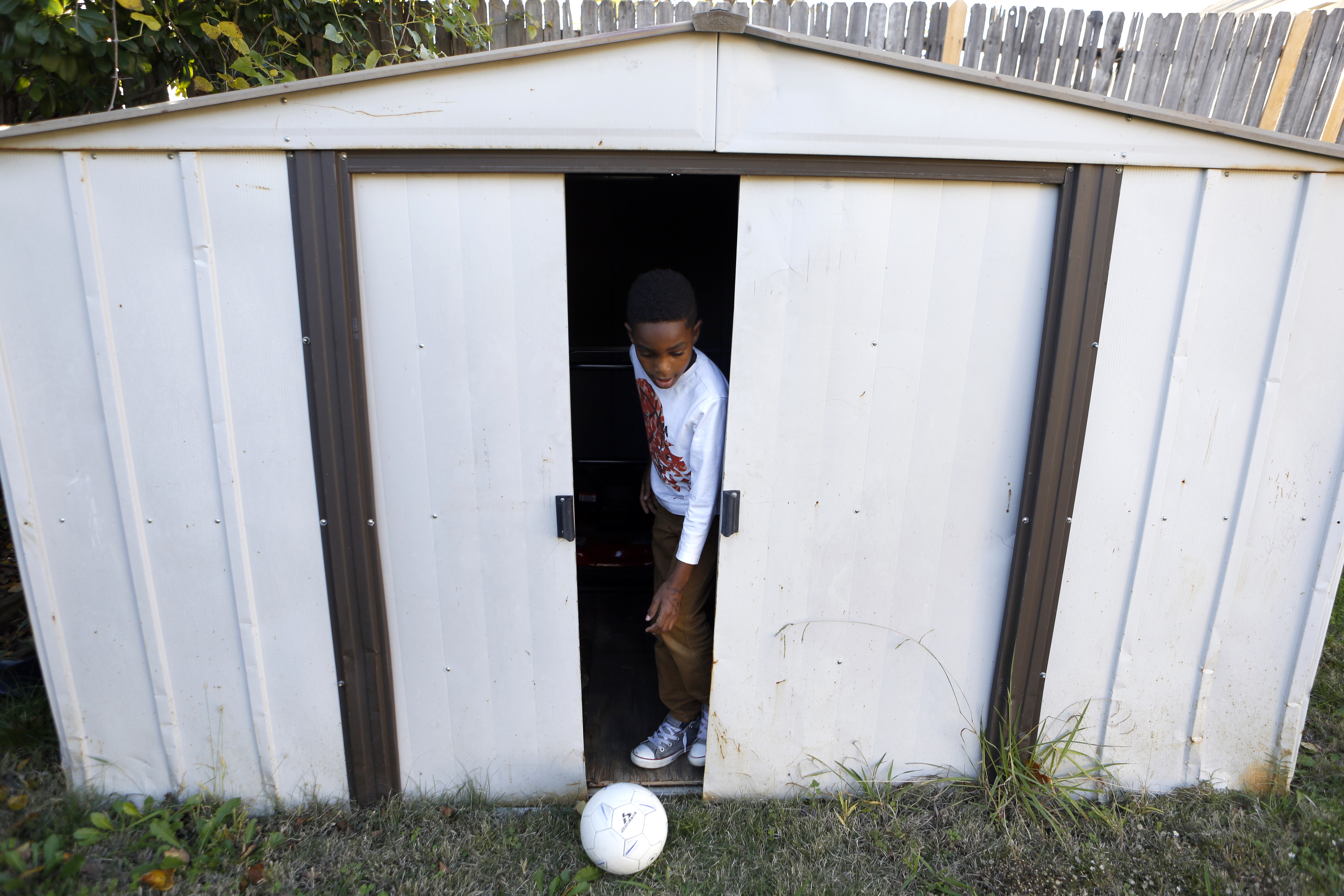 Jayden Anderson, 6, recovers the ball while playing in the backyard at rented home his family shares with a roommate in Garland. Their apartment was destroyed in a tornado in December 2015. Photographed on Monday, November 15, 2016. (photo © Lara Solt)
